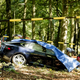 Rescue workers proceed with caution around the spot where a Tesla slammed into a tree in Baarn, on September 7, 2016.